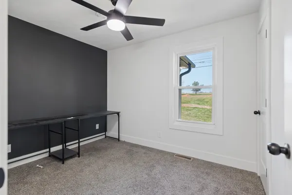 a room with window and a ceiling fan