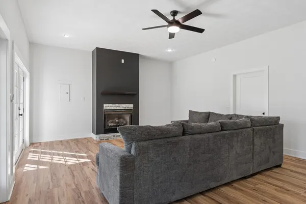 a living room with furniture and a ceiling fan