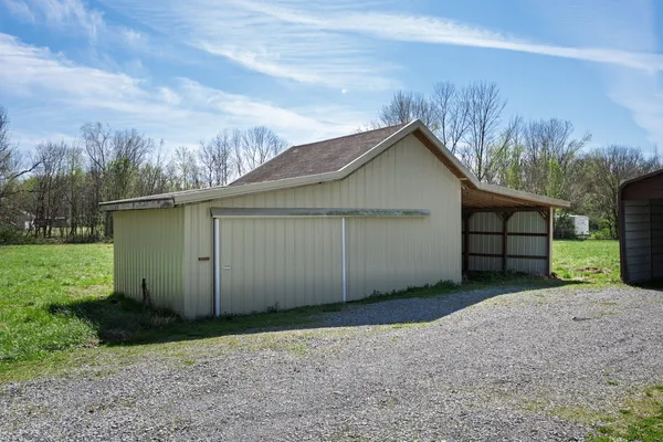 a view of a house with a yard and garage