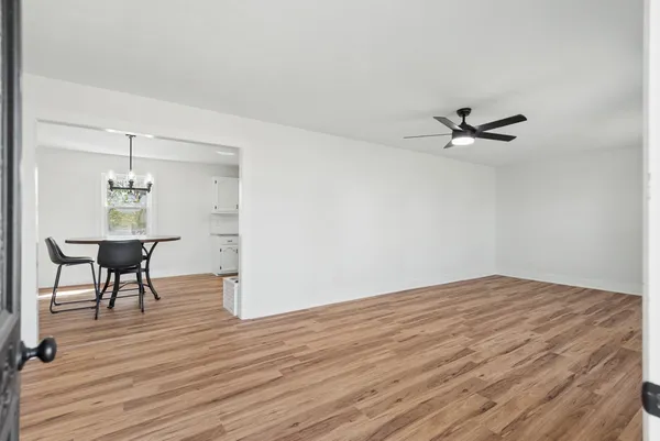 a view of a livingroom with a hardwood floor and a ceiling fan