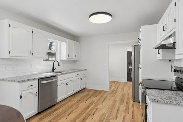 a kitchen with a sink stove and refrigerator