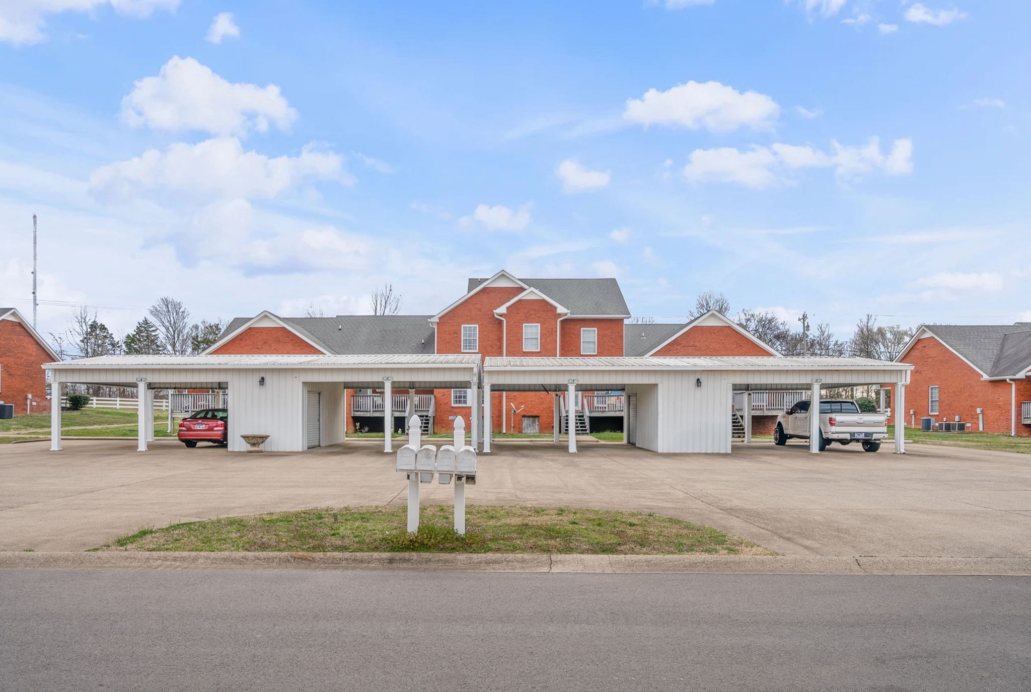 207 Bailey Lane, Unit 102 Pleasant View, TN 37146 - Photo 29 of 30 a view of a white house with a big yard and large trees