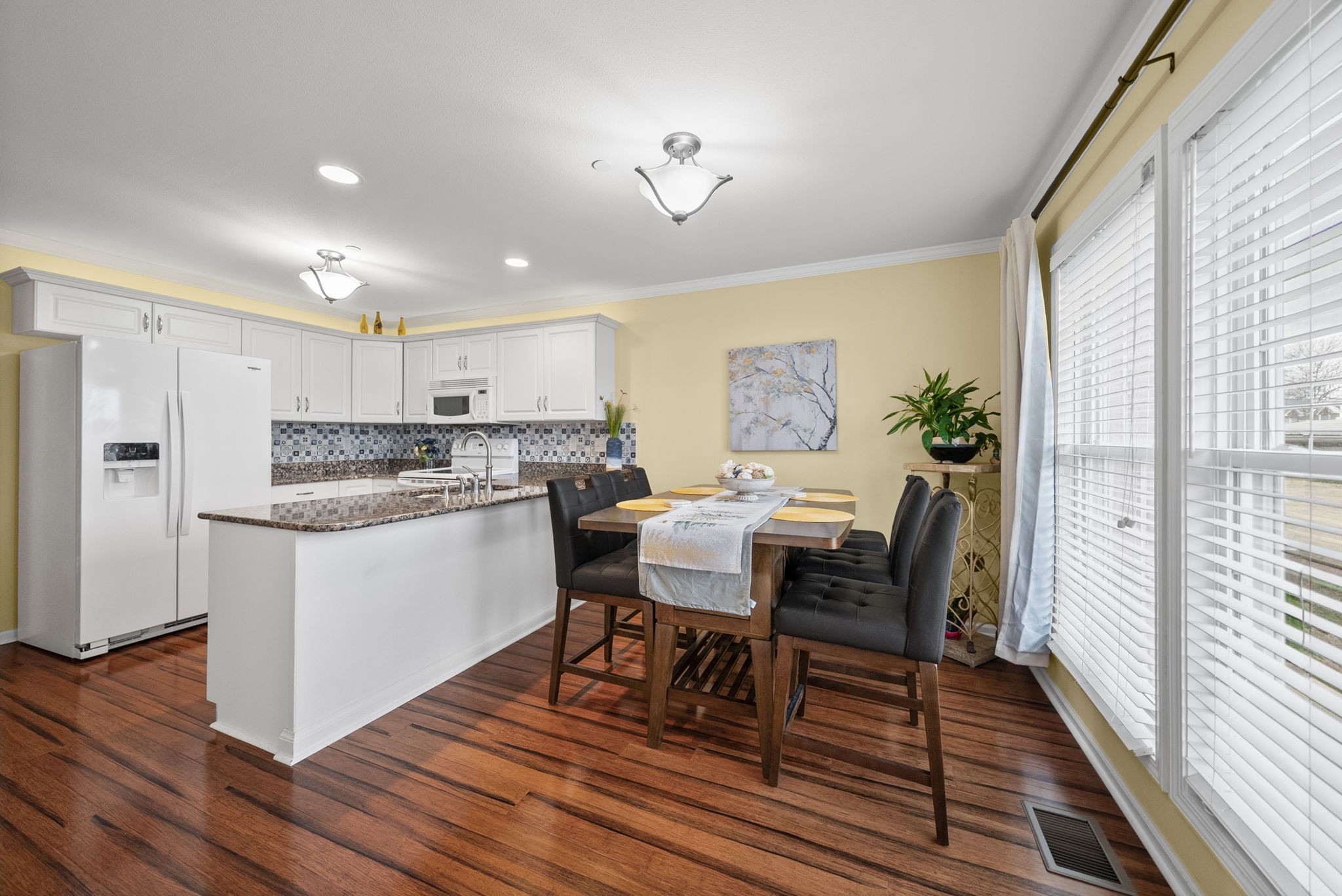 207 Bailey Lane, Unit 102 Pleasant View, TN 37146 - Photo 3 of 30 a kitchen with a table chairs refrigerator and window