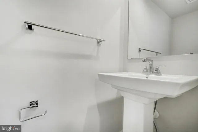 a bathroom with a sink and mirror