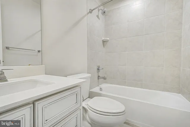 a bathroom with a sink toilet vanity and shower