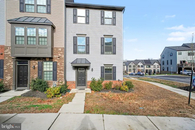 a front view of a brick house with a yard