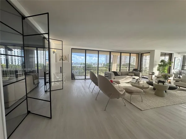 a living room with furniture and a floor to ceiling window