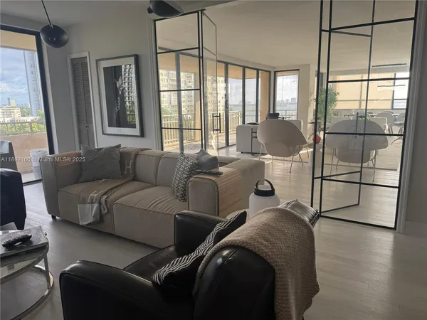 a living room with couches and a large window