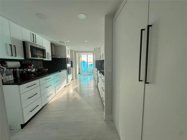 a kitchen with stainless steel appliances granite countertop a refrigerator a stove top oven a sink and dishwasher