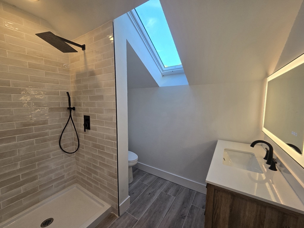 321 Riverside Drive Northampton, MA 01062 - Photo 20 of 24 a bathroom with a granite countertop sink a toilet and a mirror