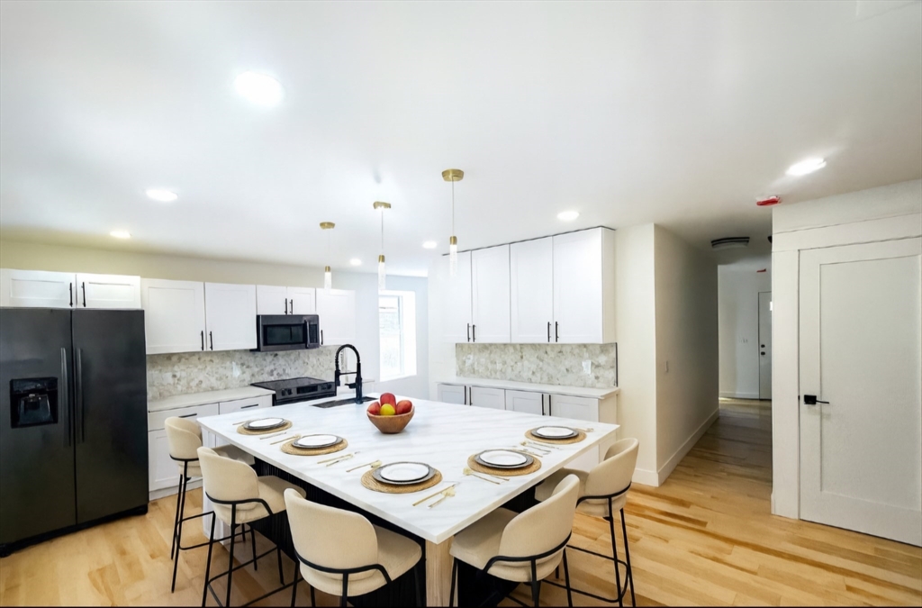 321 Riverside Drive Northampton, MA 01062 - Photo 2 of 24 a kitchen with a refrigerator a stove a sink and chairs