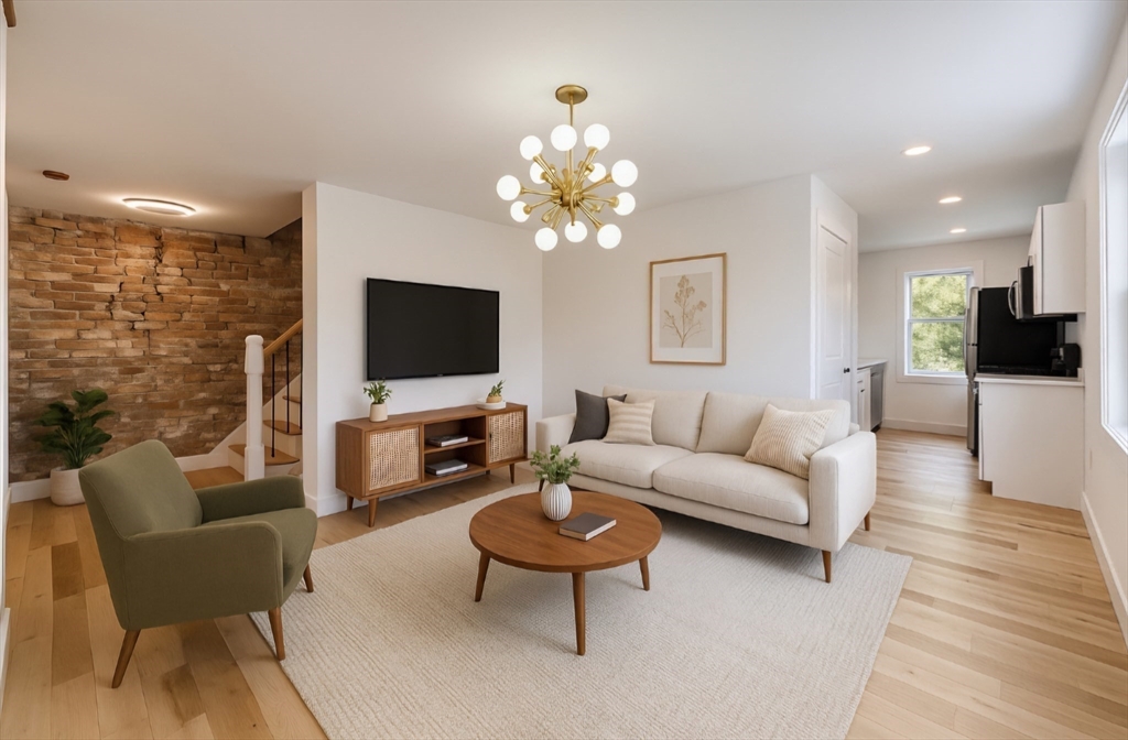 321 Riverside Drive Northampton, MA 01062 - Photo 7 of 24 a living room with furniture a flat screen tv and a chandelier