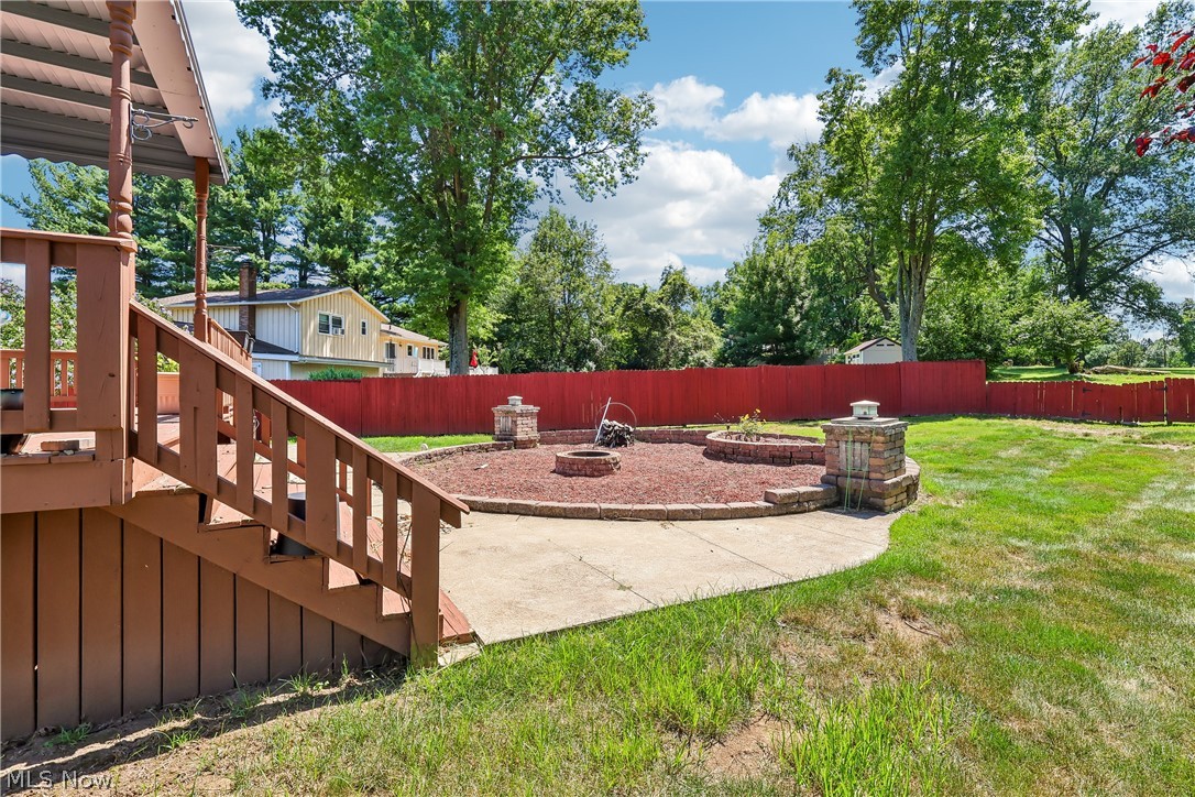 6109 North Oval Road Clinton, OH 44216 - Photo 41 of 47 Backyard featuring a circular paver patio with a central fire pit and privacy fence