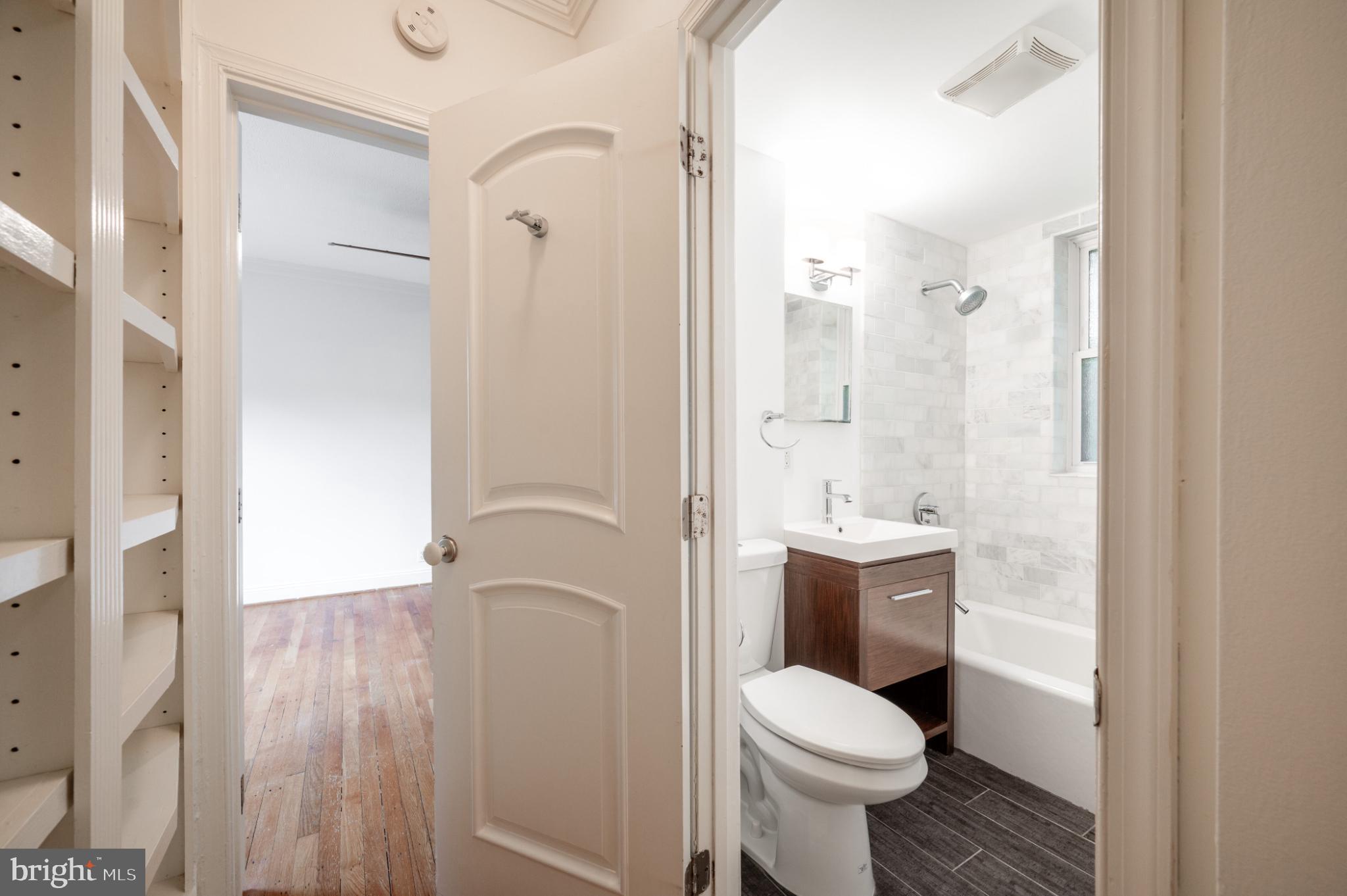 3719 12th Street Northeast, Unit 209 Washington, DC 20017 - Photo 12 of 24 Updated bathroom opens into hallway.