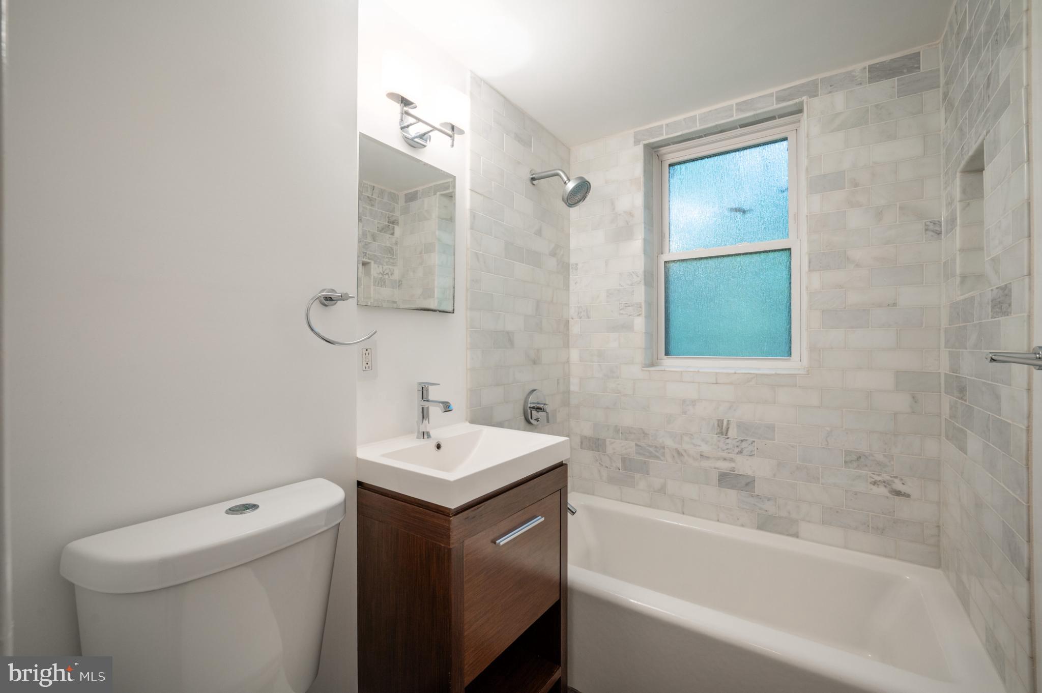 3719 12th Street Northeast, Unit 209 Washington, DC 20017 - Photo 13 of 24 Modern bathroom with elegant tilework.