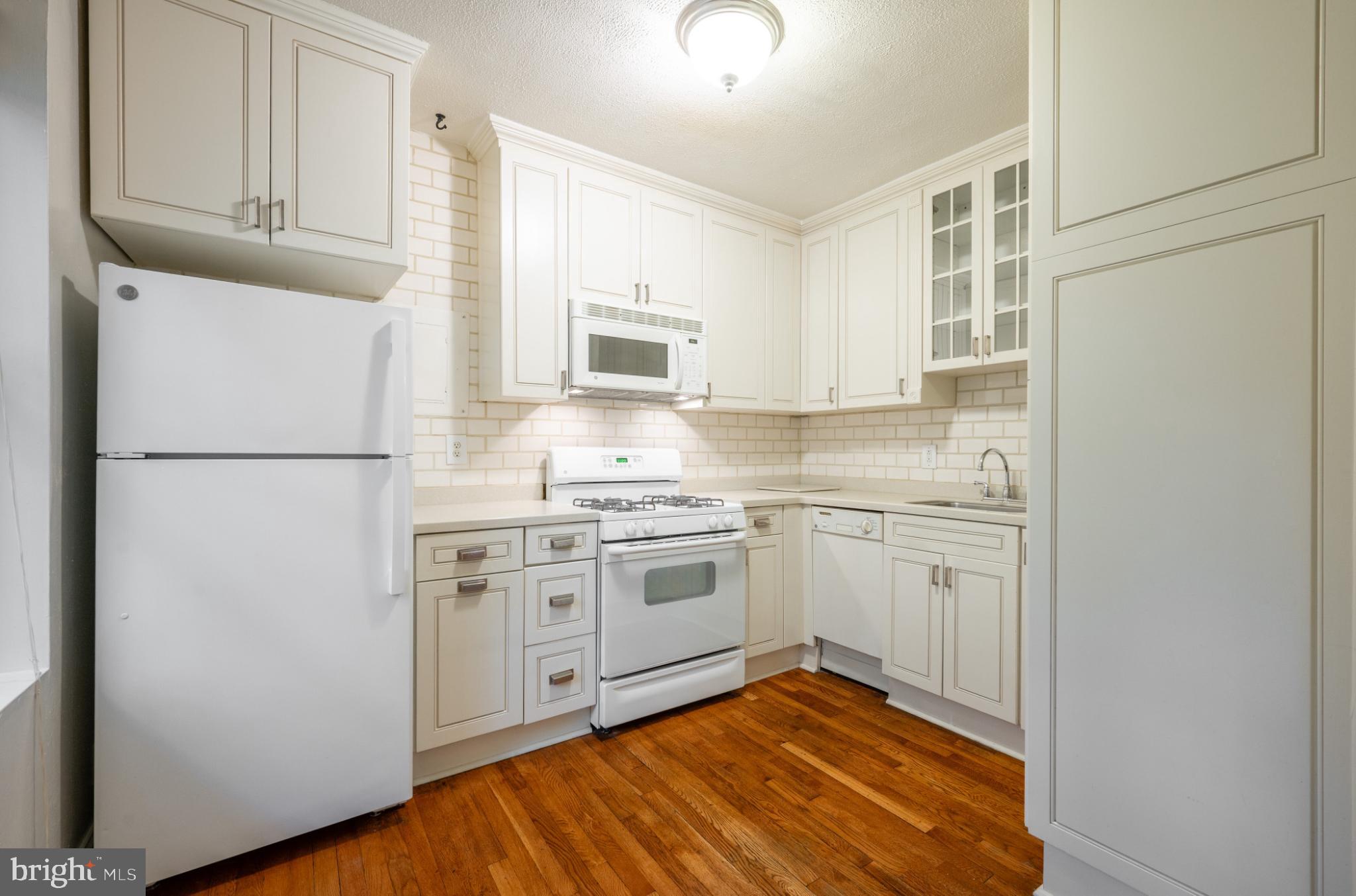 3719 12th Street Northeast, Unit 209 Washington, DC 20017 - Photo 6 of 24 Charming kitchen with subway tile backsplash.