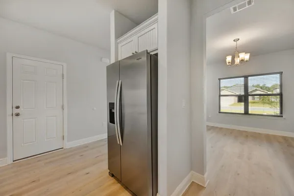 a view of a refrigerator in kitchen and wooden floor
