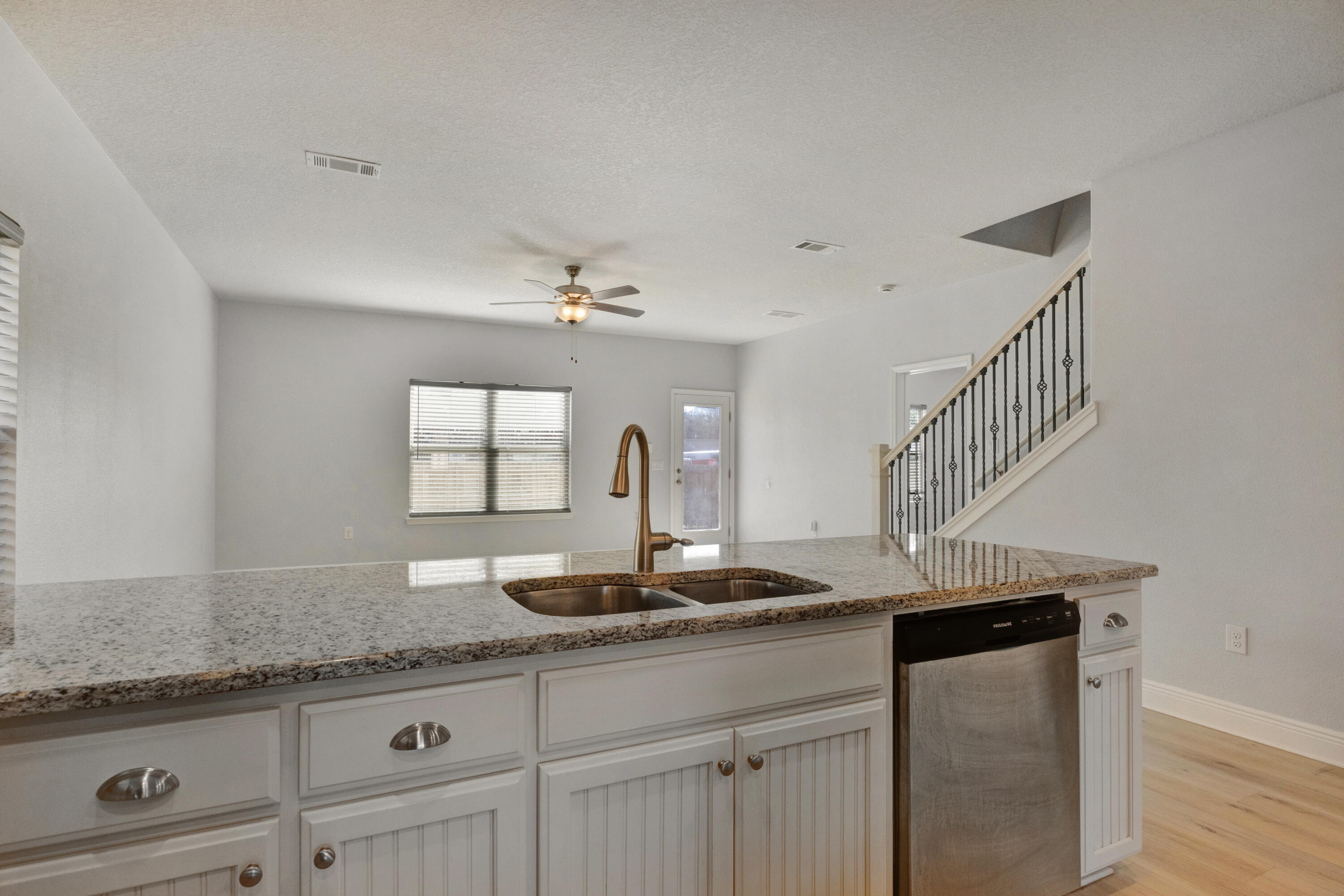 231 Baycliff Drive Crestview, FL 32536 - Photo 13 of 49 a kitchen with granite countertop a sink a stove and cabinets