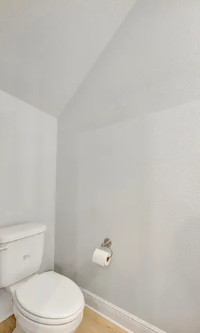 a bathroom with a granite countertop sink a toilet and bathtub