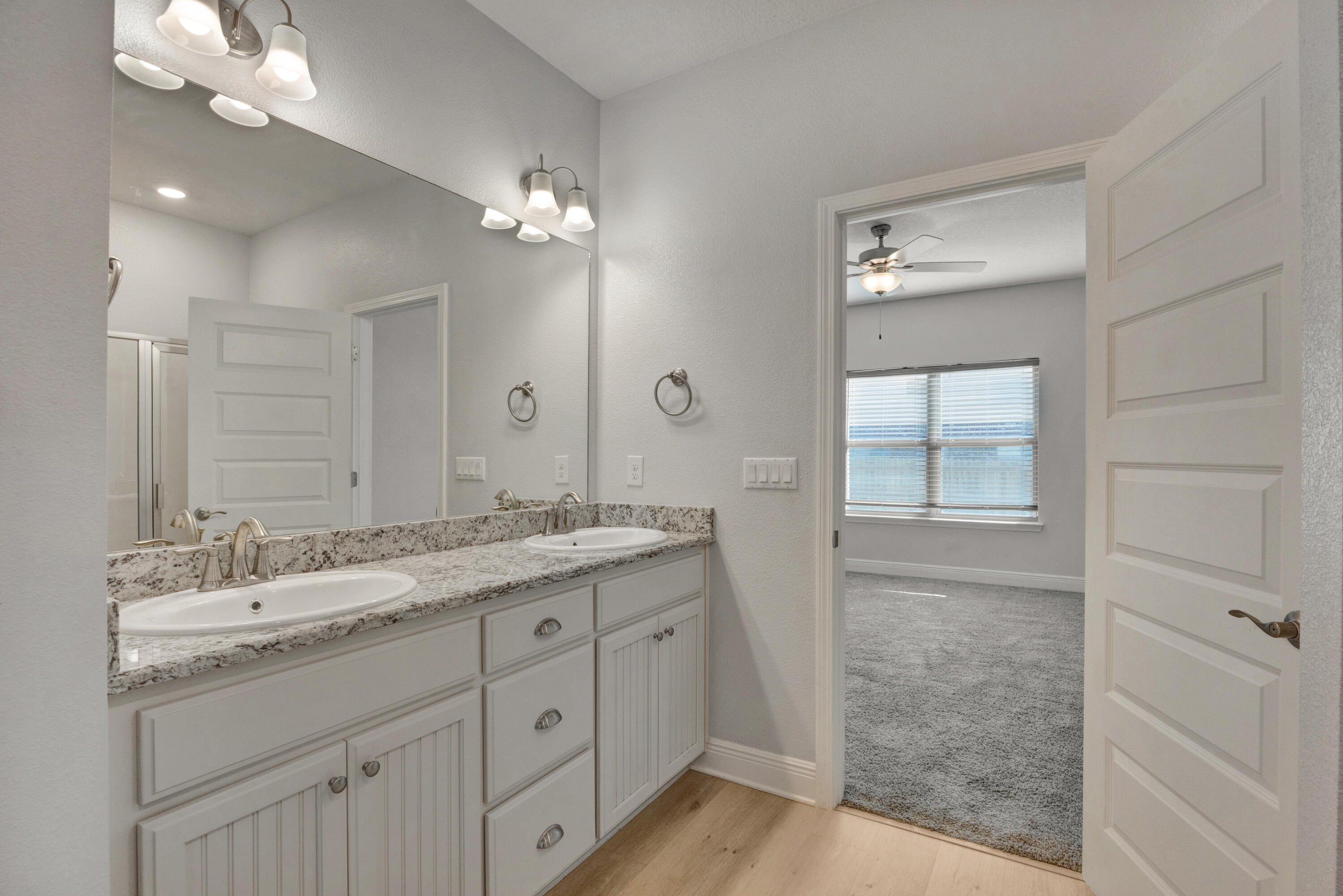 231 Baycliff Drive Crestview, FL 32536 - Photo 20 of 49 a bathroom with a granite countertop sink a light fixture and a mirror