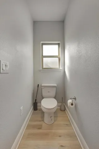 a view of a livingroom with wooden floor and a window