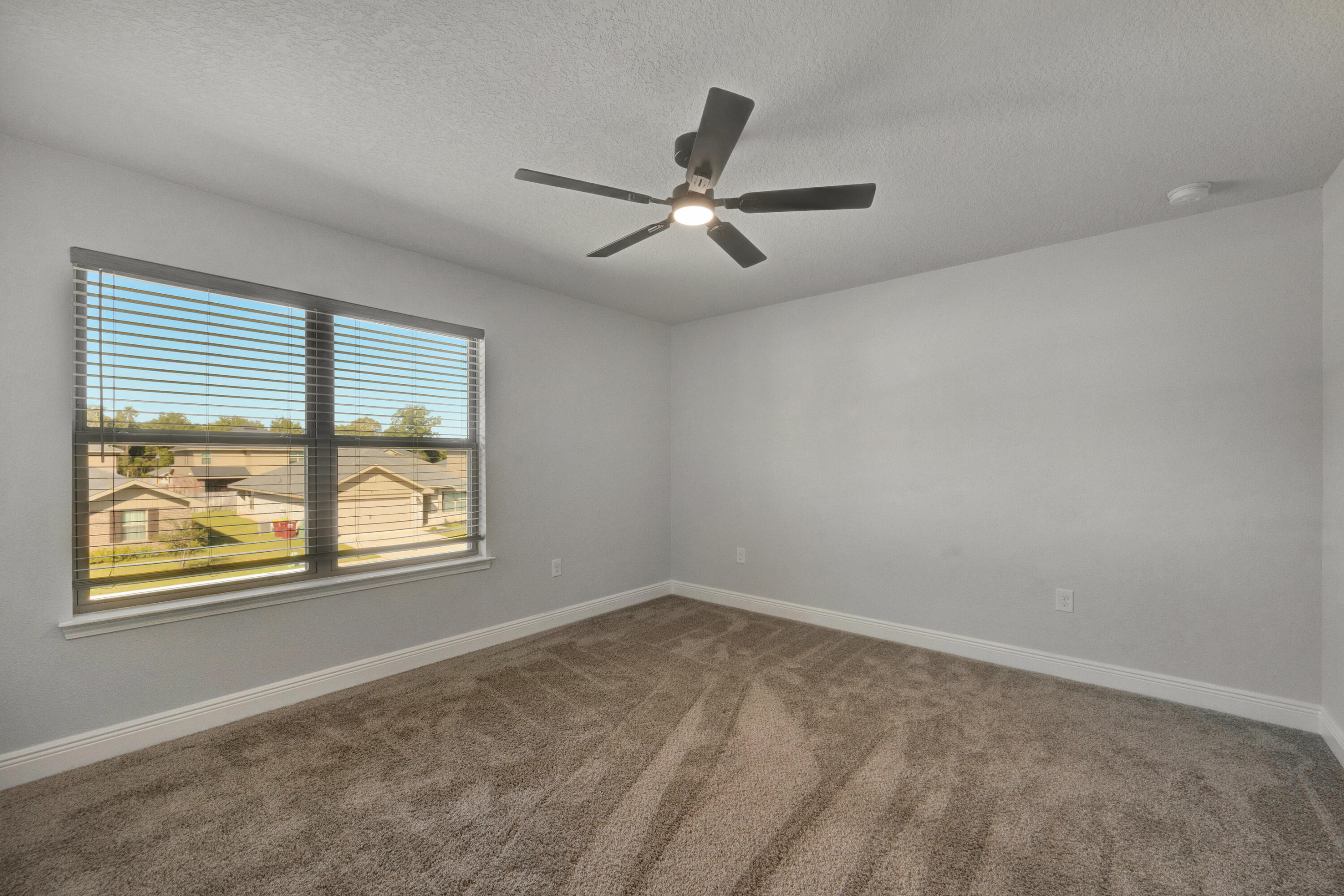 231 Baycliff Drive Crestview, FL 32536 - Photo 29 of 49 an empty room with windows and ceiling fan