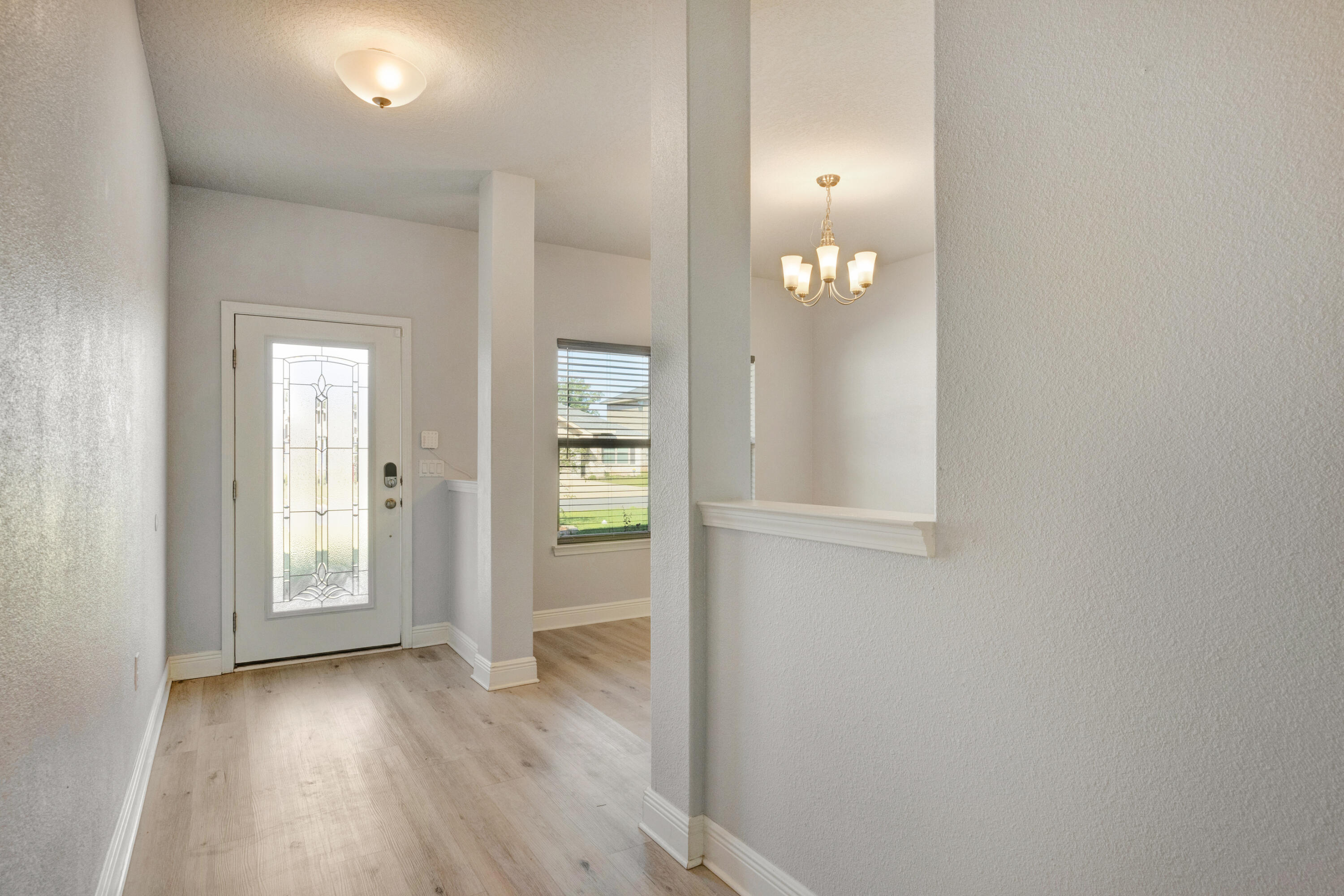 231 Baycliff Drive Crestview, FL 32536 - Photo 3 of 49 wooden floor in an empty room with a window