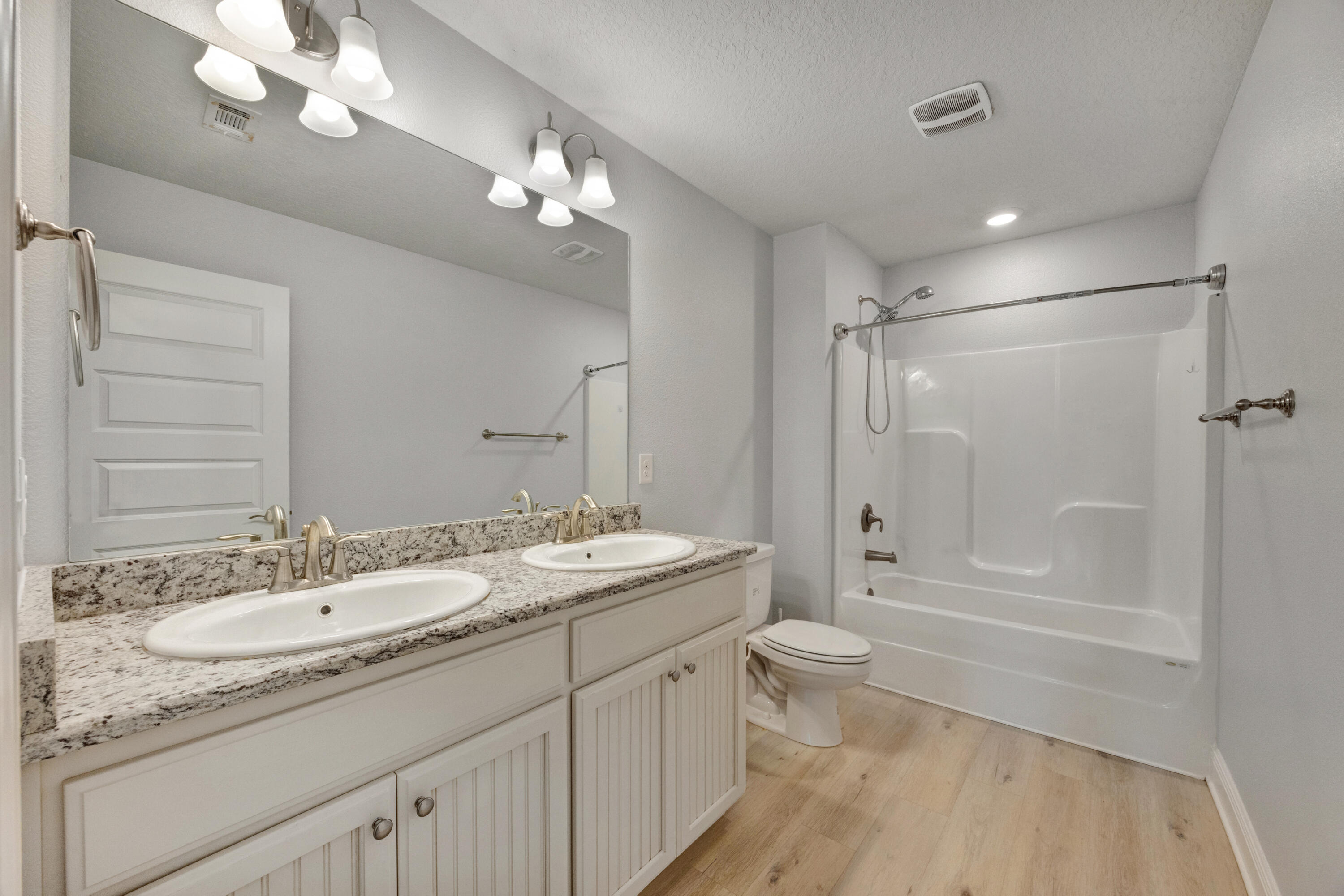 231 Baycliff Drive Crestview, FL 32536 - Photo 38 of 49 a bathroom with a granite countertop sink a toilet a large mirror and shower