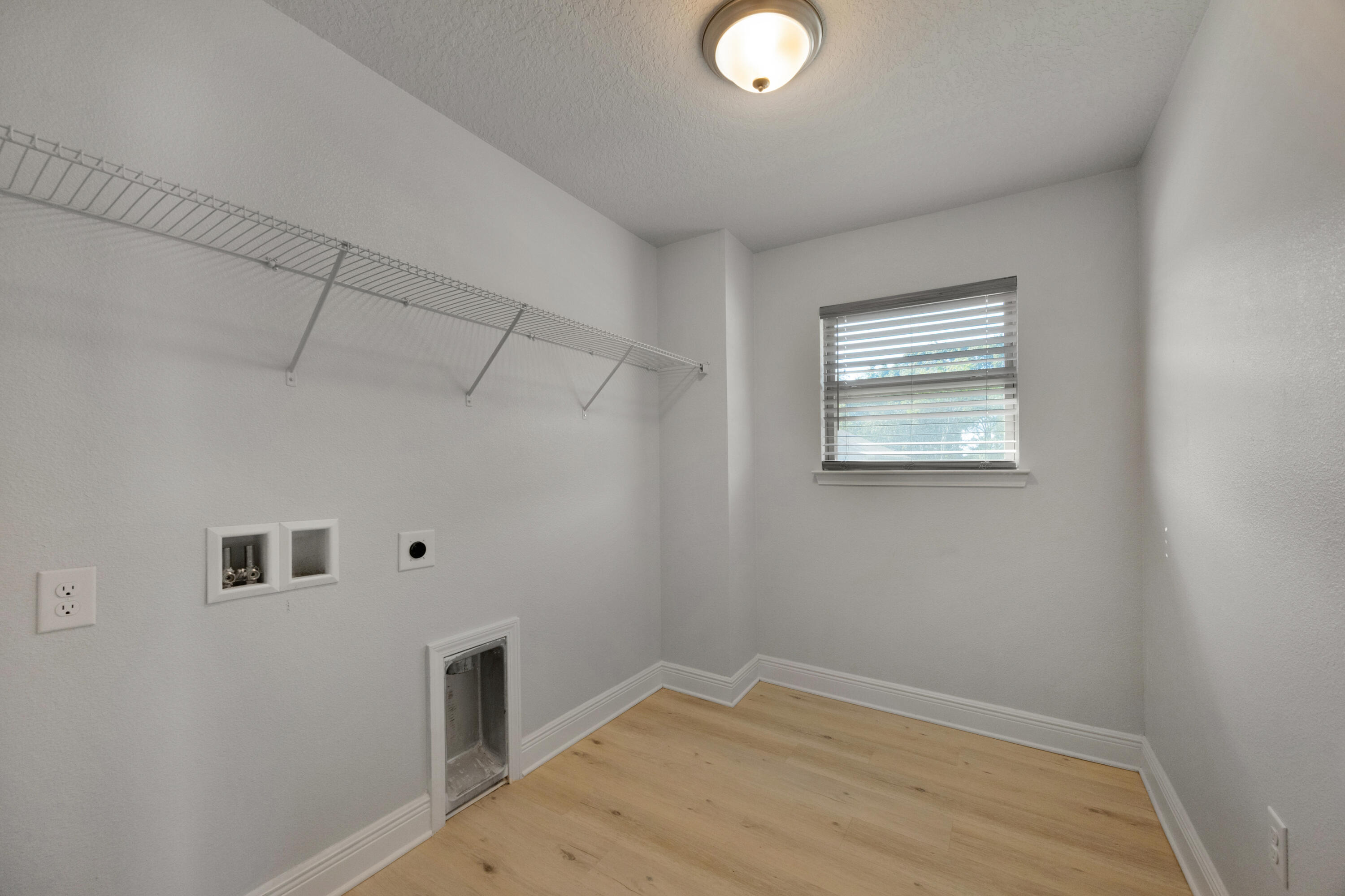 231 Baycliff Drive Crestview, FL 32536 - Photo 39 of 49 a view of a livingroom with wooden floor and a window