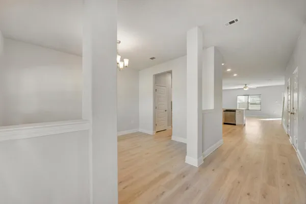 a view of a hallway with wooden floor