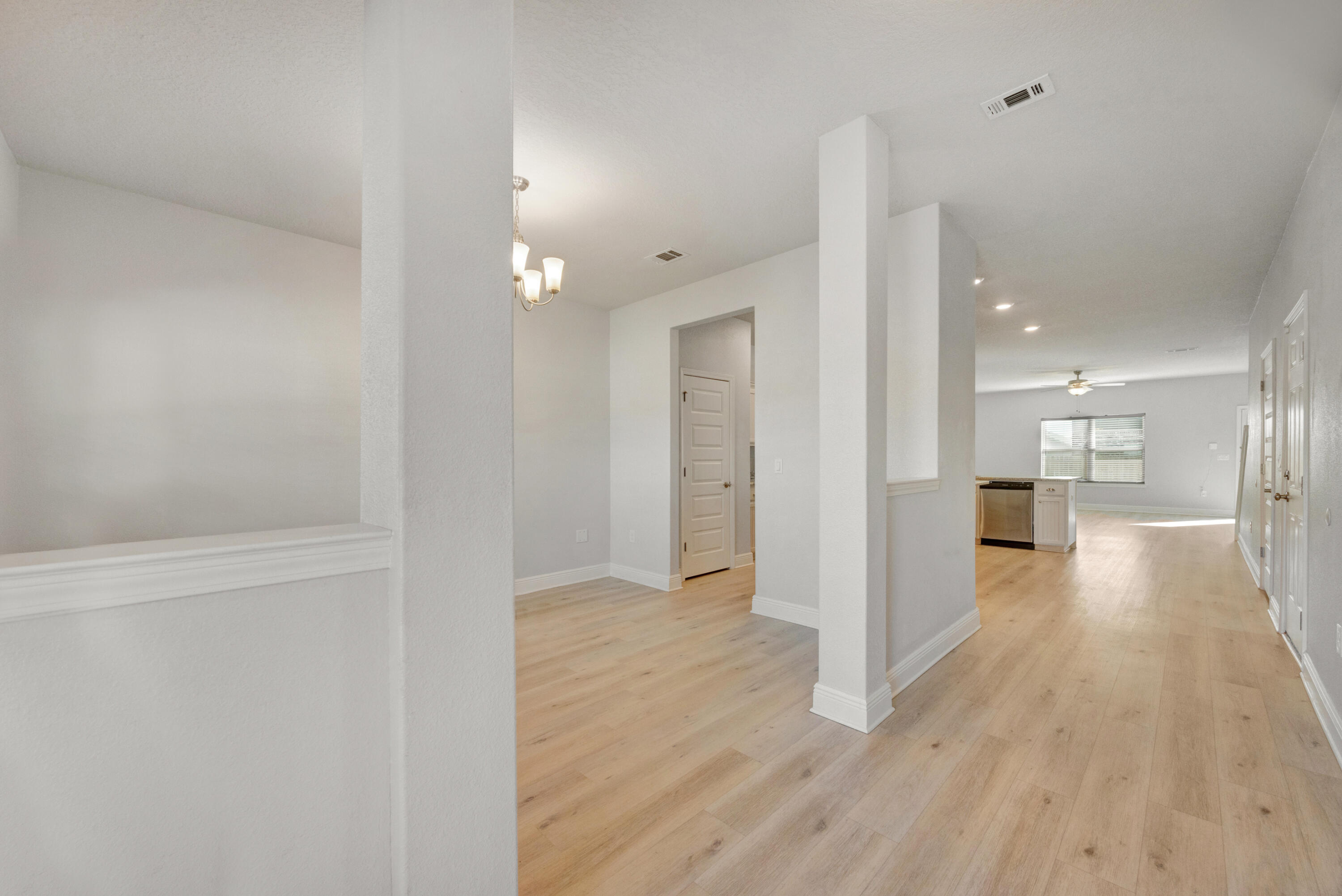231 Baycliff Drive Crestview, FL 32536 - Photo 4 of 49 a view of a hallway with wooden floor