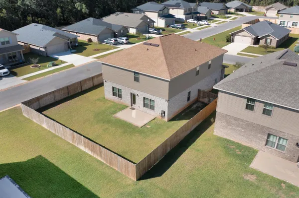 an aerial view of a house with a swimming pool