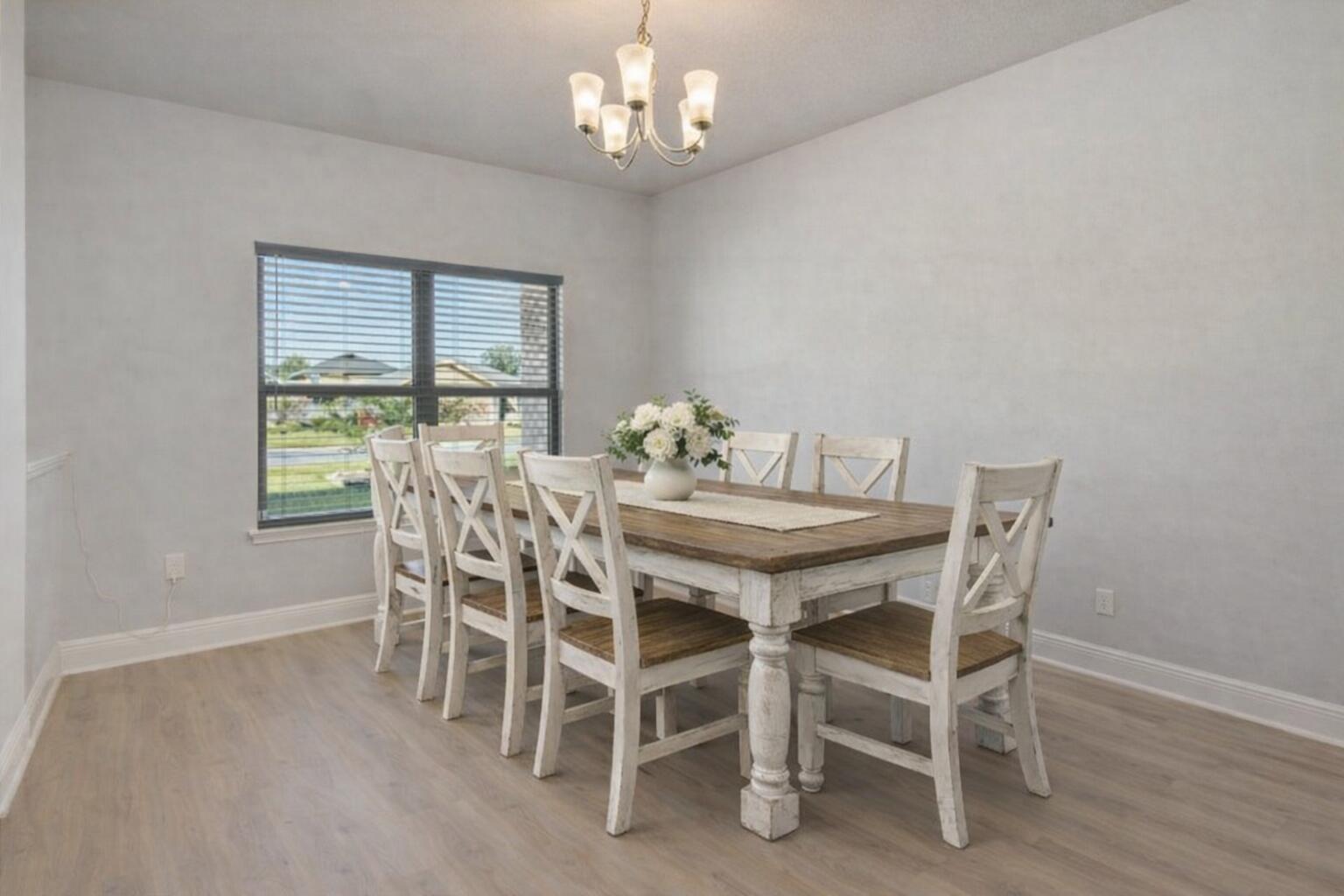 231 Baycliff Drive Crestview, FL 32536 - Photo 5 of 49 a view of a dining room with furniture a chandelier and wooden floor