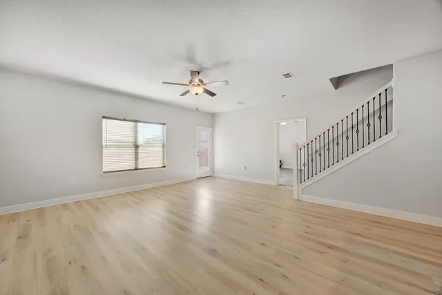 a view of a kitchen with furniture and wooden floor