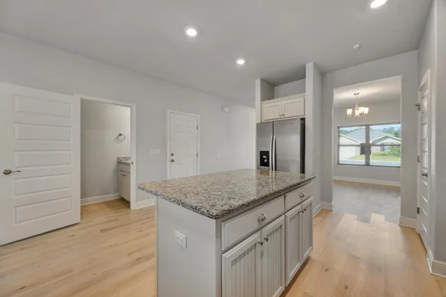 a bathroom with a granite countertop sink a mirror and vanity