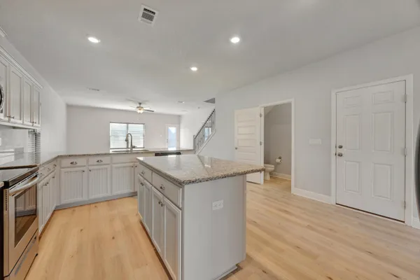 a kitchen with granite countertop a stove and a sink