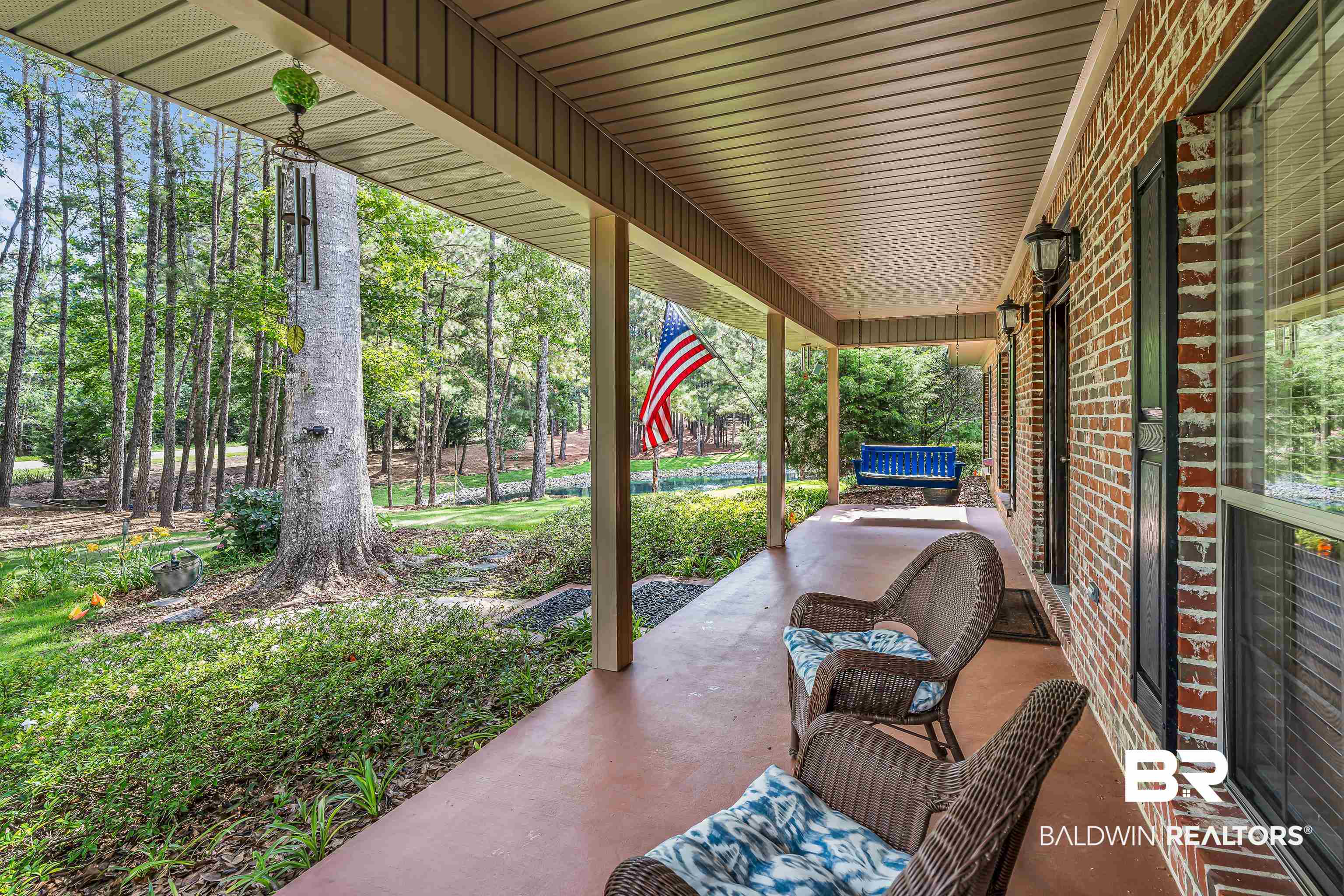 7014 Blakeley Road Daphne, AL 36527 - Photo 13 of 45 Covered front porch with a red-toned concrete surface