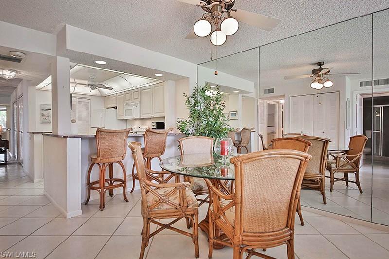 651 Seaview Court, Unit B207 Marco Island, FL 34145 - Photo 2 of 17 a view of a dining room and livingroom with furniture