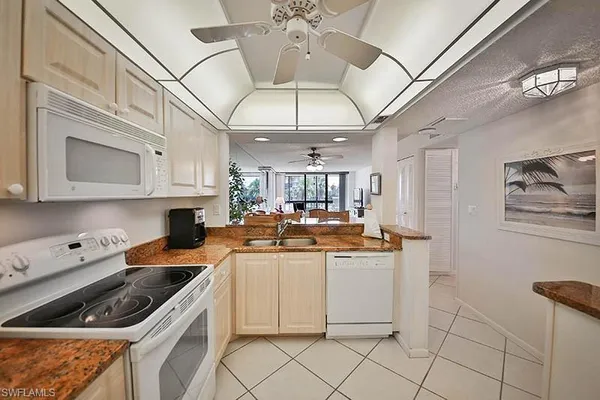 a kitchen with a stove cabinets and window
