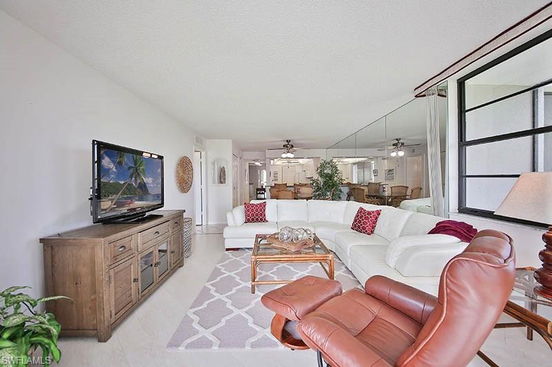 651 Seaview Court, Unit B207 Marco Island, FL 34145 - Photo 6 of 17 a living room with furniture and a flat screen tv