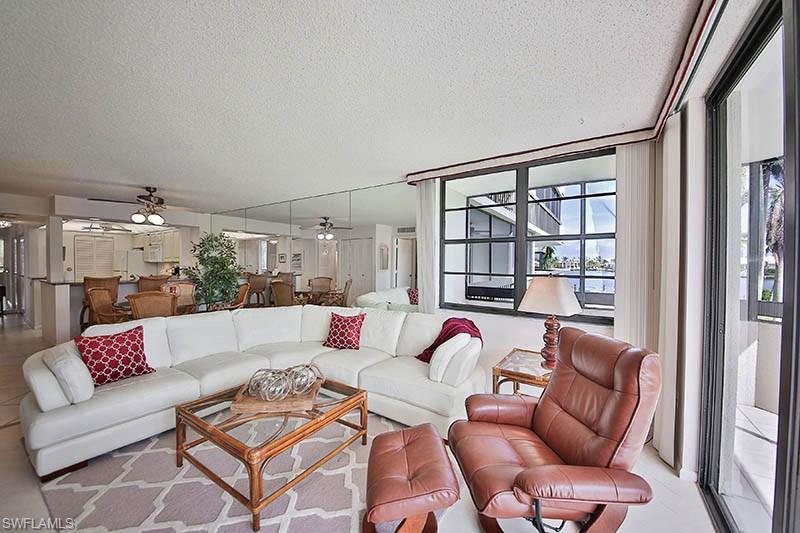 651 Seaview Court, Unit B207 Marco Island, FL 34145 - Photo 7 of 17 a living room with furniture and a large window