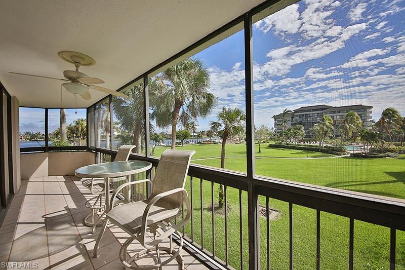651 Seaview Court, Unit B207 Marco Island, FL 34145 - Photo 9 of 17 a view of a porch with chairs and backyard