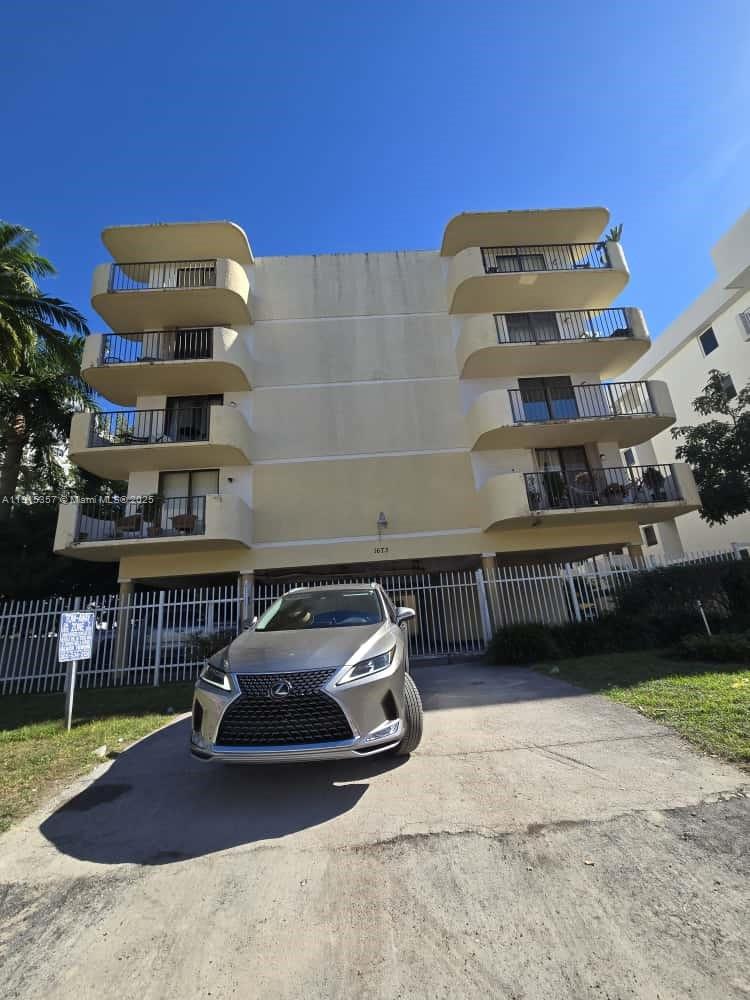 1673 Bay Road, Unit 301 Miami Beach, FL 33139 - Photo 1 of 18 a car parked in front of a building