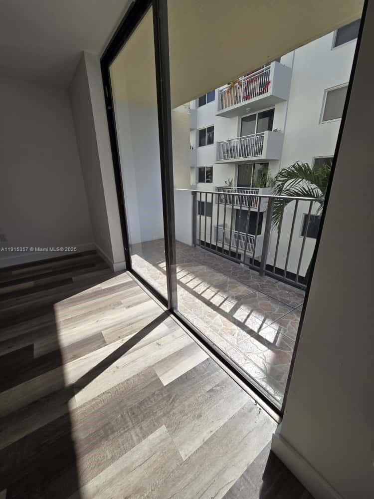 1673 Bay Road, Unit 301 Miami Beach, FL 33139 - Photo 16 of 18 a view of staircase with white walls and windows