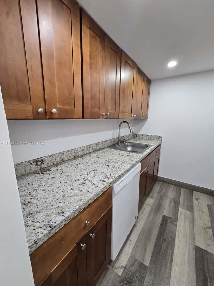1673 Bay Road, Unit 301 Miami Beach, FL 33139 - Photo 6 of 18 a bathroom with a granite countertop sink and a mirror