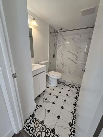 a bathroom with a toilet and a shower