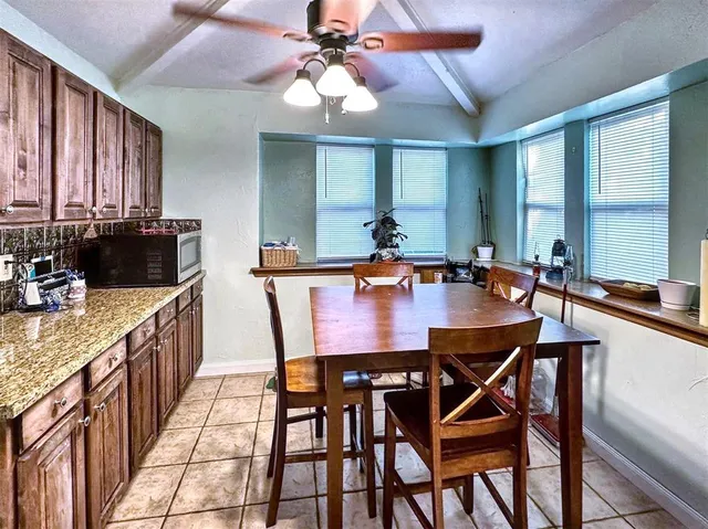 a dining table with chairs and window