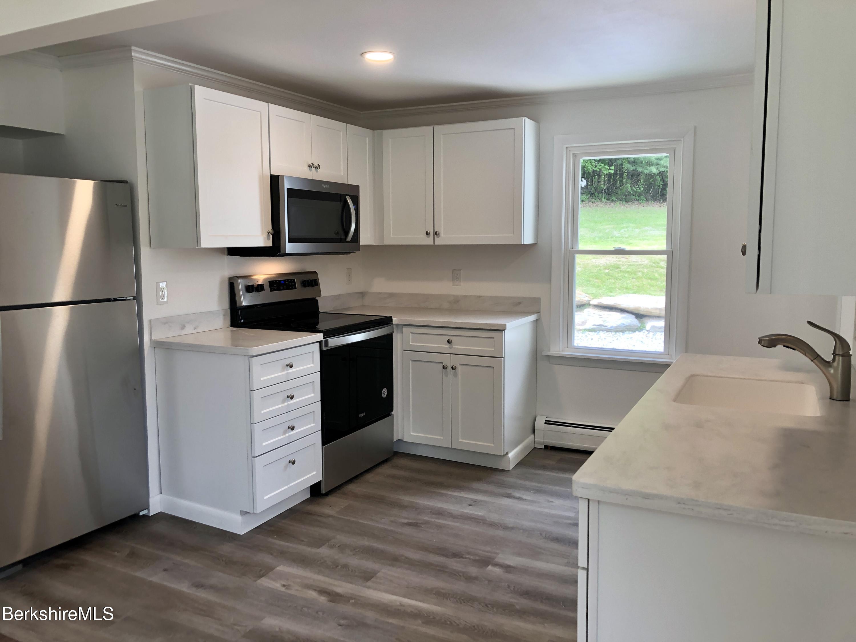 660 State Road Richmond, MA 01254 - Photo 5 of 15 a kitchen with a refrigerator stove and microwave