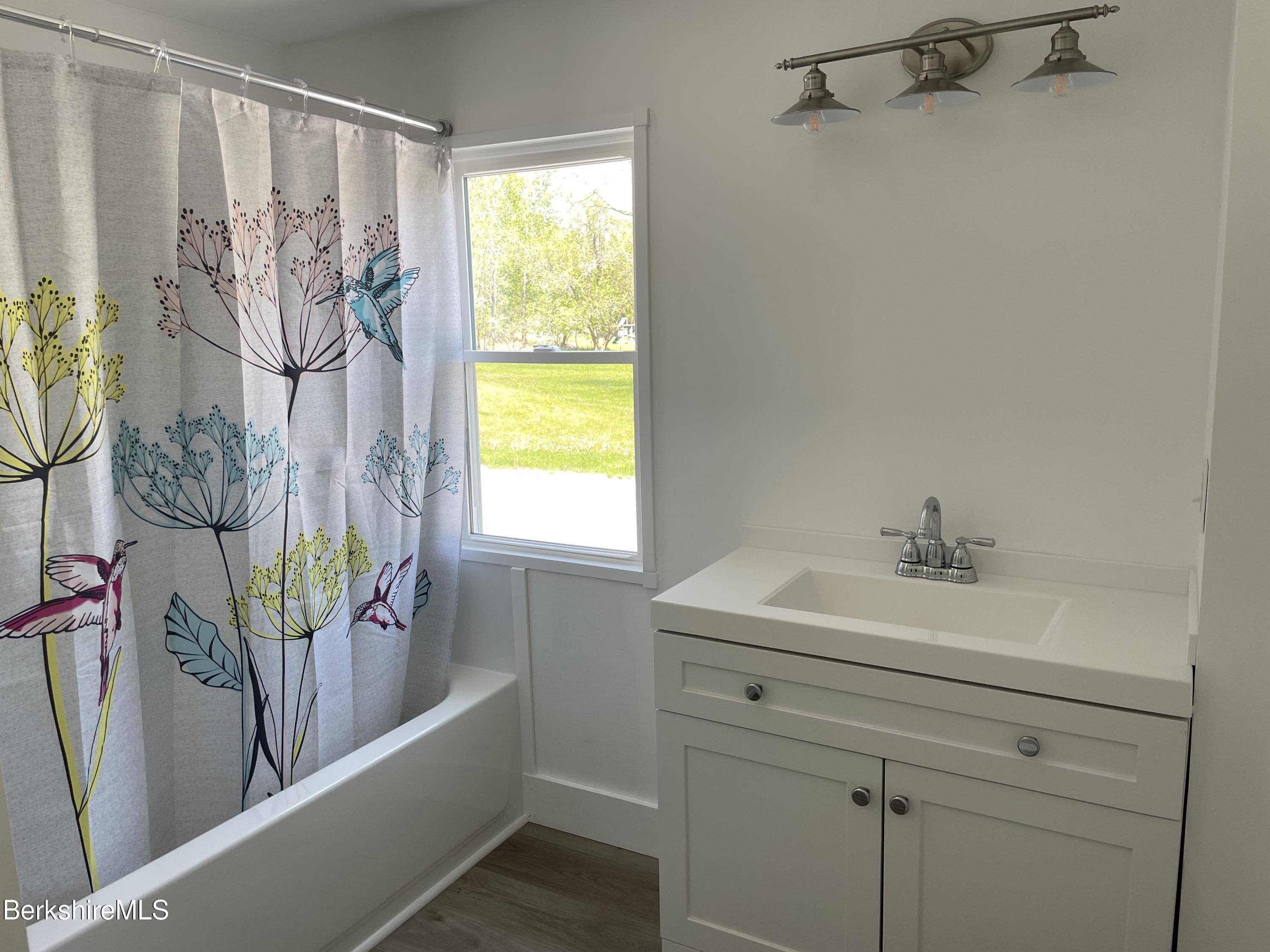 660 State Road Richmond, MA 01254 - Photo 8 of 15 a bathroom with a bathtub sink and mirror