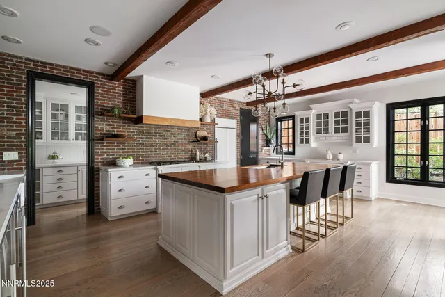 a living room with fireplace furniture and a large window